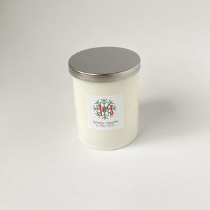 Winter hearth candle in white jar